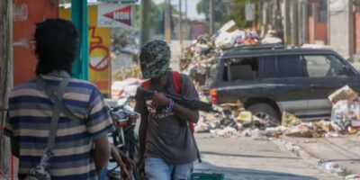 Armed members of the G9 gang stand guard at their roadblock in Port-au-Prince, Haiti, on Monday, March 11, 2024. ODELYN JOSEPH / AP