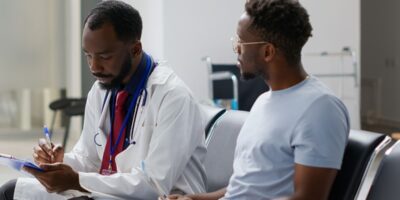 "A man sitting with his doctor